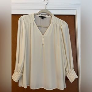 Cream colored long sleeve blouse